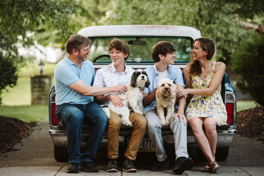 family sitting in the bed of a vintage pick up truck during a family photo session