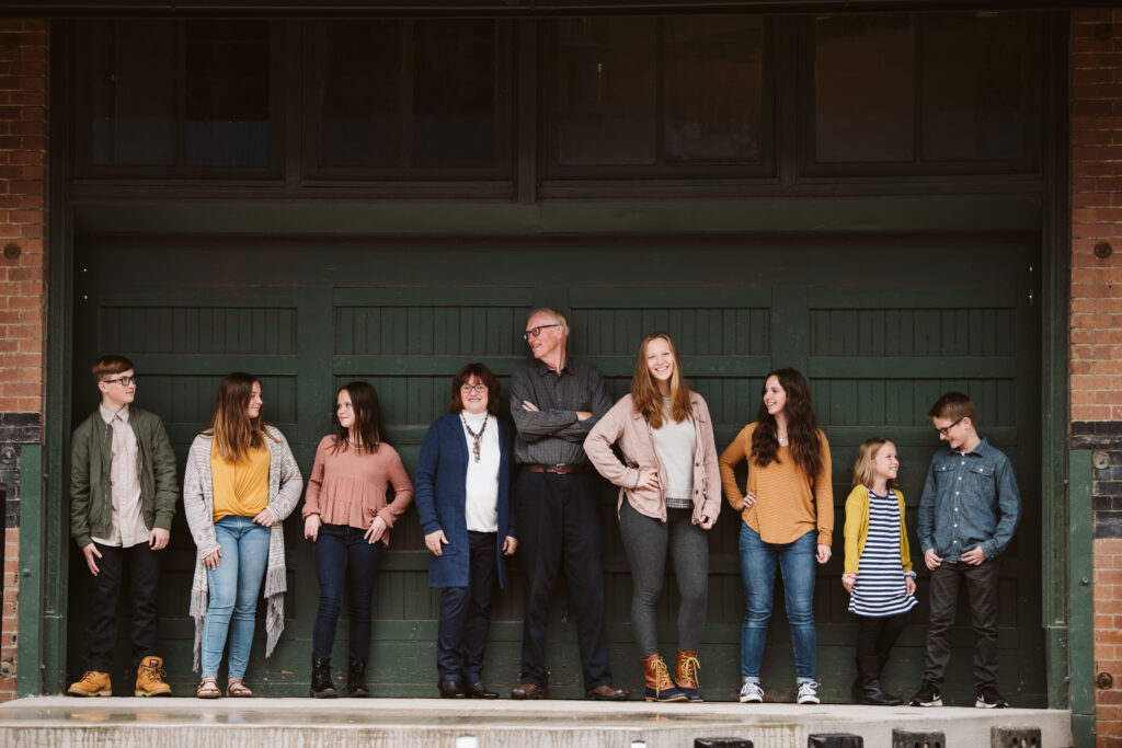 family standing in front of green door in Pittsburgh