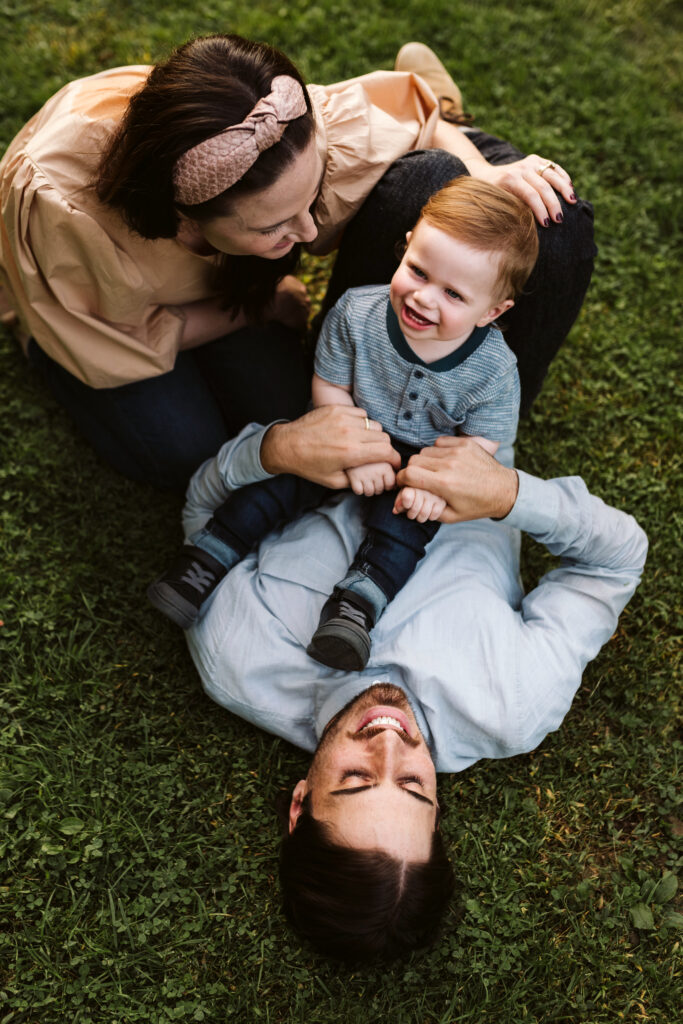 family playing on a field during a photo session
