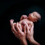 Newborn baby in his fathers hands