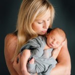 Portrait of a mother with her newborn baby son in studio. Photo by Laura Mares Photography, Pittsburgh Newborn Photographer.