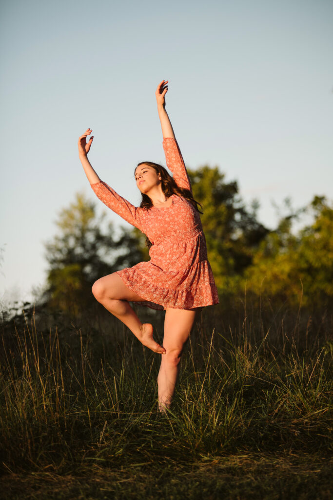 Portrait of a senior girl dancing through a field at sunset. Photo by Laura Mares Photography, Pittsburgh Senior Photographer