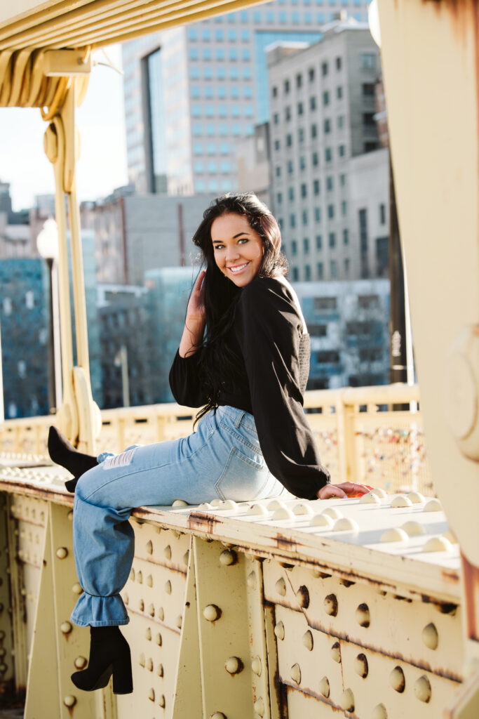 High School Senior portrait of a girl sitting on a bridge in downtown Pittsburgh, PA