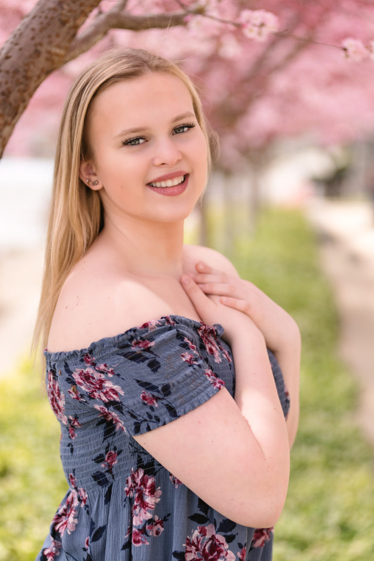 senior girl near cherry blossoms on the north Shore of Pittsburgh, photographed by Pittsburgh Photographer, Laura Mares Photography