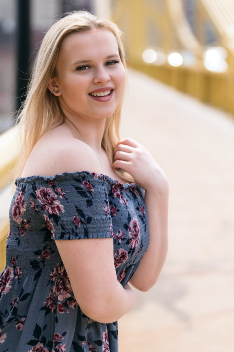 senior girl smiling on the Roberto Clemente Bridge near on the North Shore of Pittsburgh, photographed by Pittsburgh Photographer, Laura Mares Photography