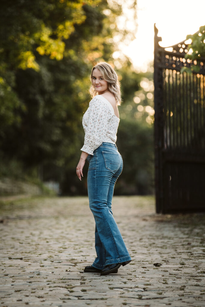 senior girl walking on cobblestone street