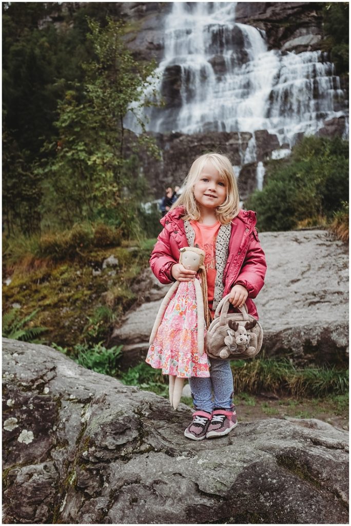Ella & Tutu standing near a waterfall in Norway. Photo by Laura Mares, Pittsburgh Child Photographer.