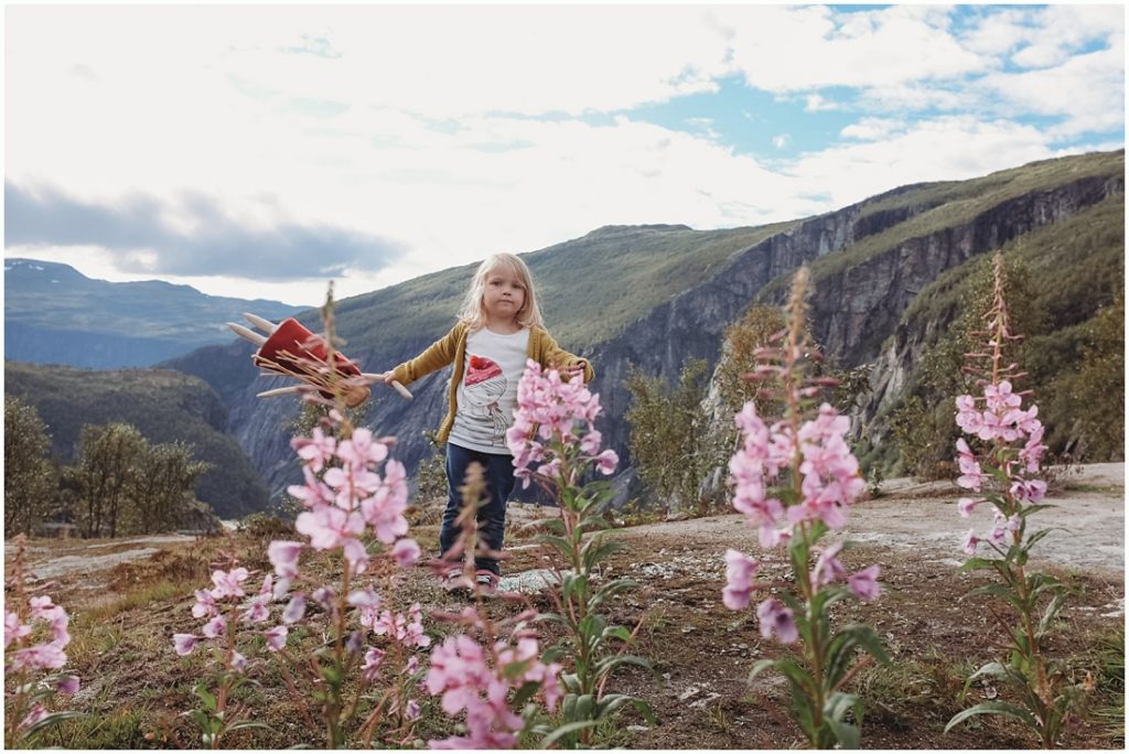 Ella & Tutu standing in flowers in Norway. Photo by Laura Mares, Pittsburgh Child Photographer.