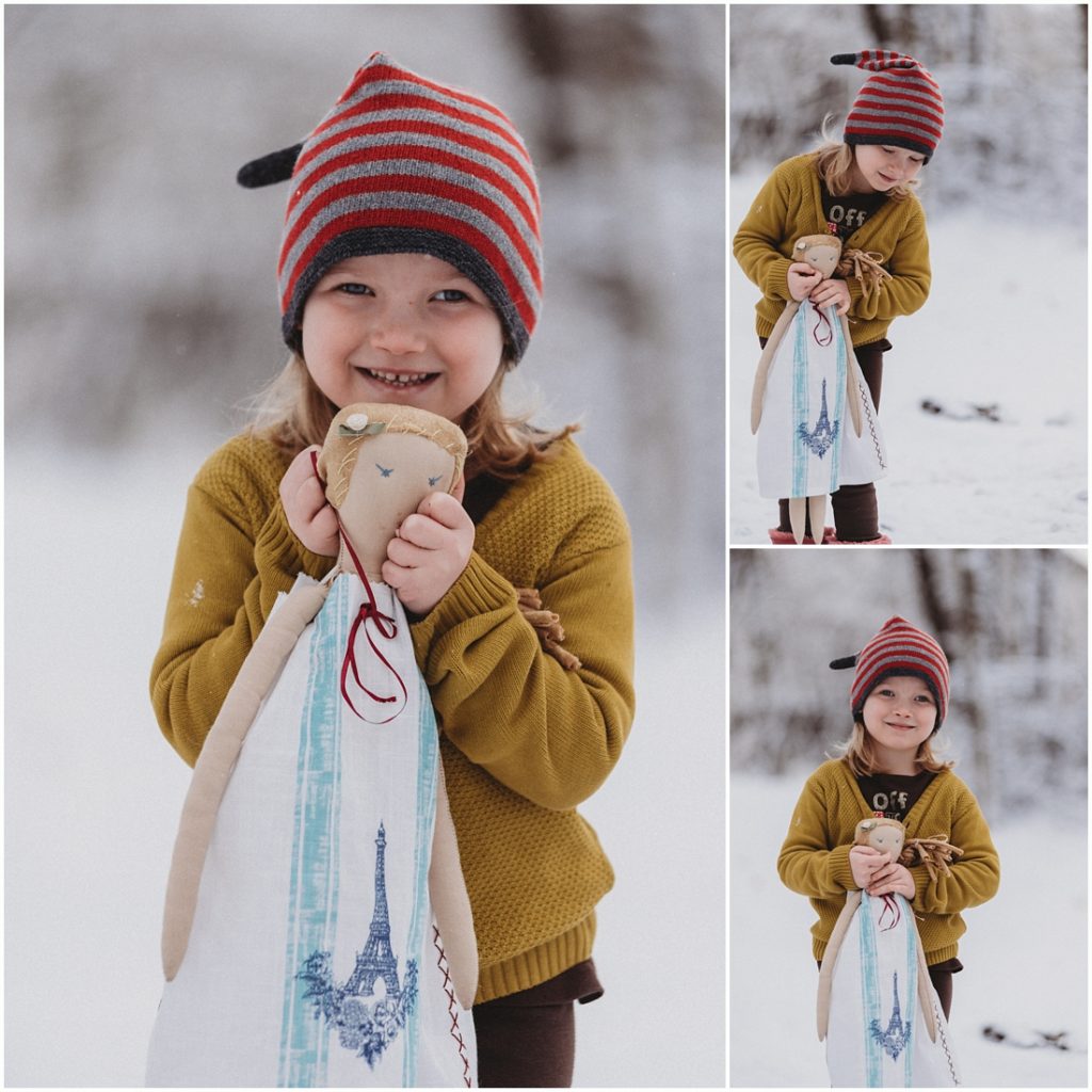 A girl with her doll standing in the snow. Photo by Laura Mares, Pittsburgh Lifestyle Photographer