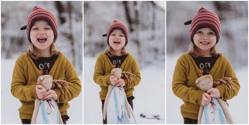 A girl with her doll standing in the snow. Photo by Laura Mares, Pittsburgh Lifestyle Photographer