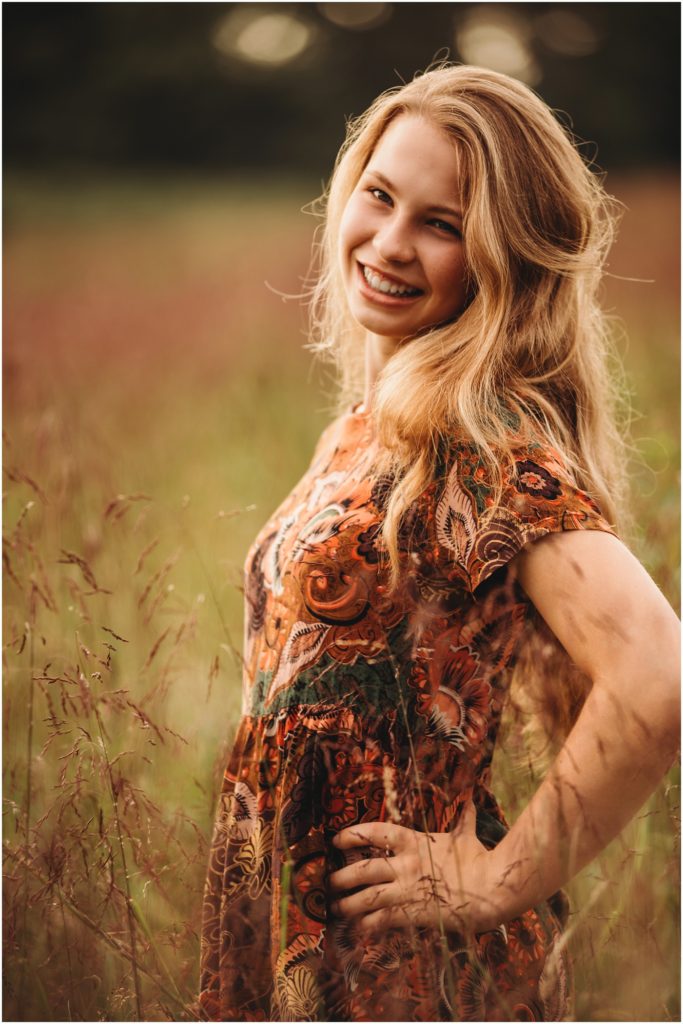 high school senior portraits of a girl in a field at sunset taken by Pittsburgh Senior Photographer, Laura Mares Photography