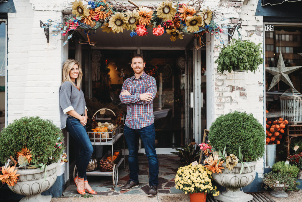 Husband and wife standing in front of a floral shop. Photo by Pittsburgh Portrait Photographer, Laura Mares Photography.