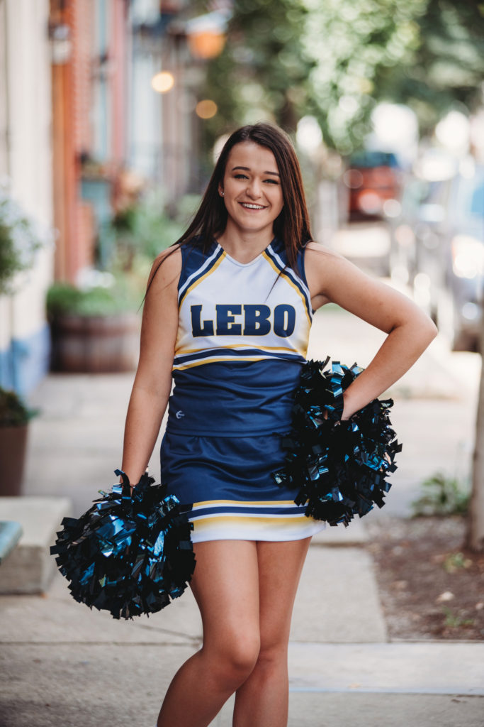 Senior photo of a beautiful high school senior girl in her cheer uniform. Photo by Laura Mares Photography, Pittsburgh Senior Photographer