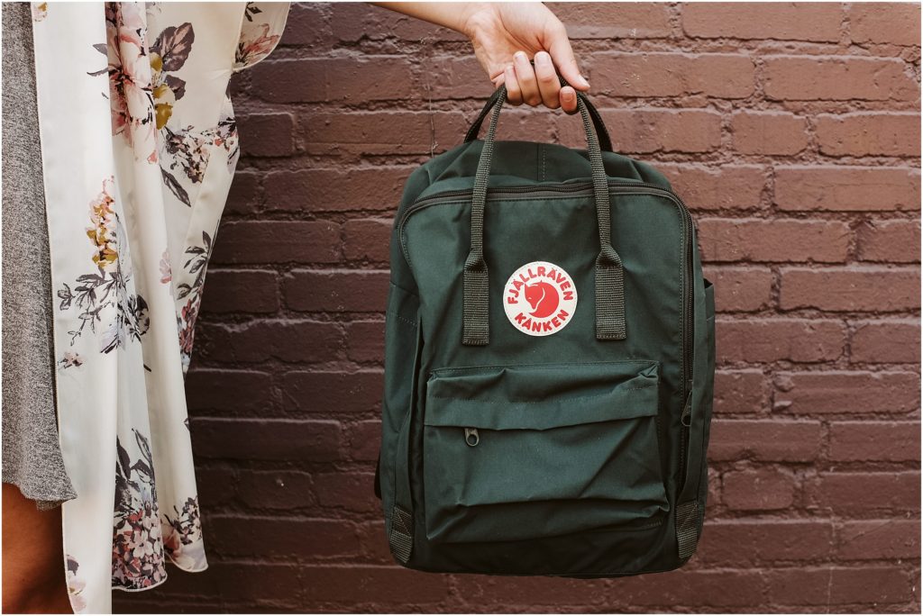 Girl holding a fjallraven Kanken backpack. Photo by Laura Mares Photography, Pittsburgh Lifestyle Photographer.