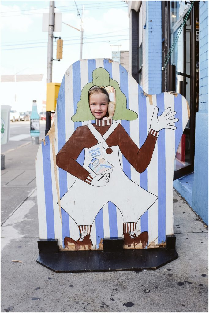 Girl standing infant of a grandpa Joe's sign. Photo by Laura Mares Photography, Pittsburgh Child Photographer.