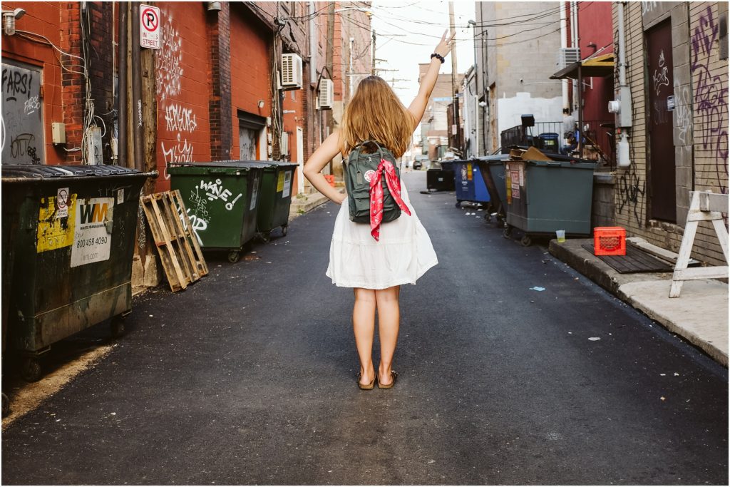 Girl standing in an alley in the strip district. Photo by Laura Mares Photography, Pittsburgh Senior Photographer.