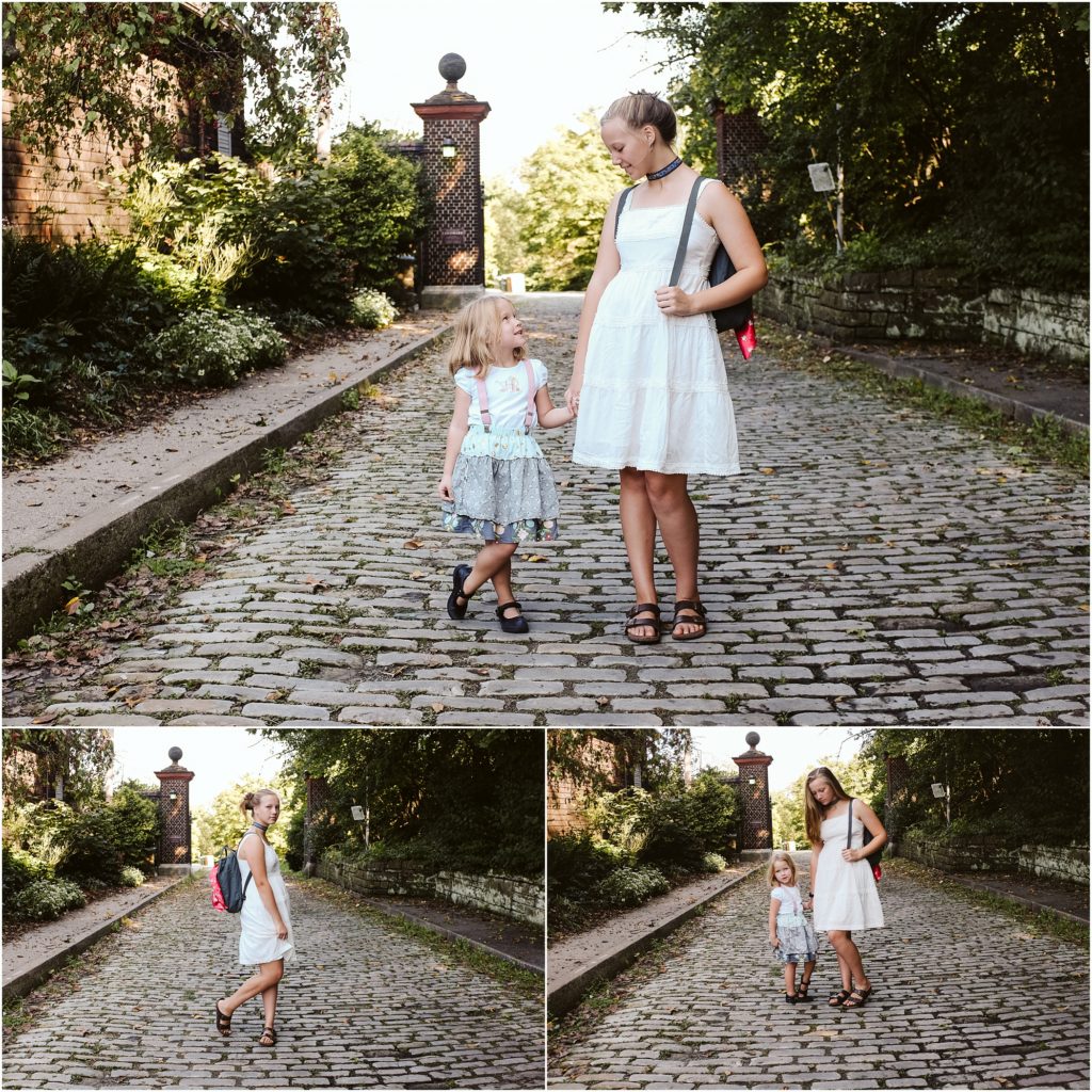 Sisters standing on a cobblestone road. Photo by Laura Mares Photography, Pittsburgh Lifestyle Photographer.