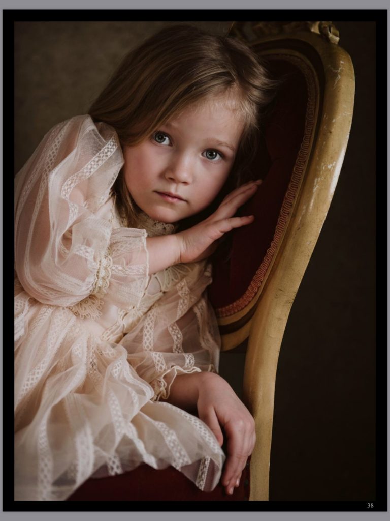 Portrait of a child sitting on a velvet chair. Portrait by Pittsburgh Child Photographer, Laura Mares Photography.
