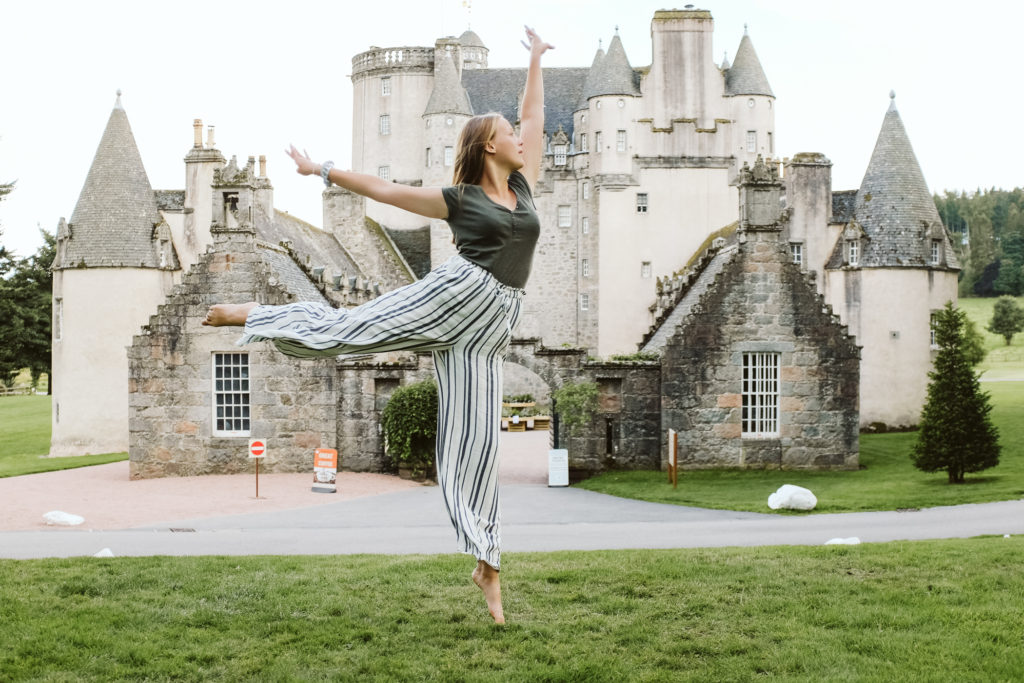 Teenager dancing near Castle Fraser in Scotland. Photograph by Laura Mares Photography.