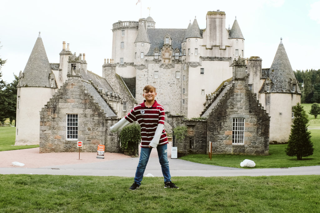 Child dancing near Castle Fraser in Scotland. Photograph by Laura Mares Photography.