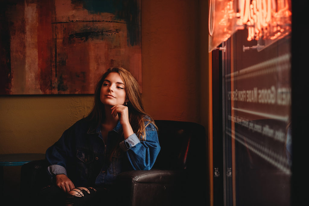 A portrait of a senior girl drinking coffee at Uptown Coffee near Pittsburgh. Portrait by Laura Mares Photography, Pittsburgh Senior Photographer
