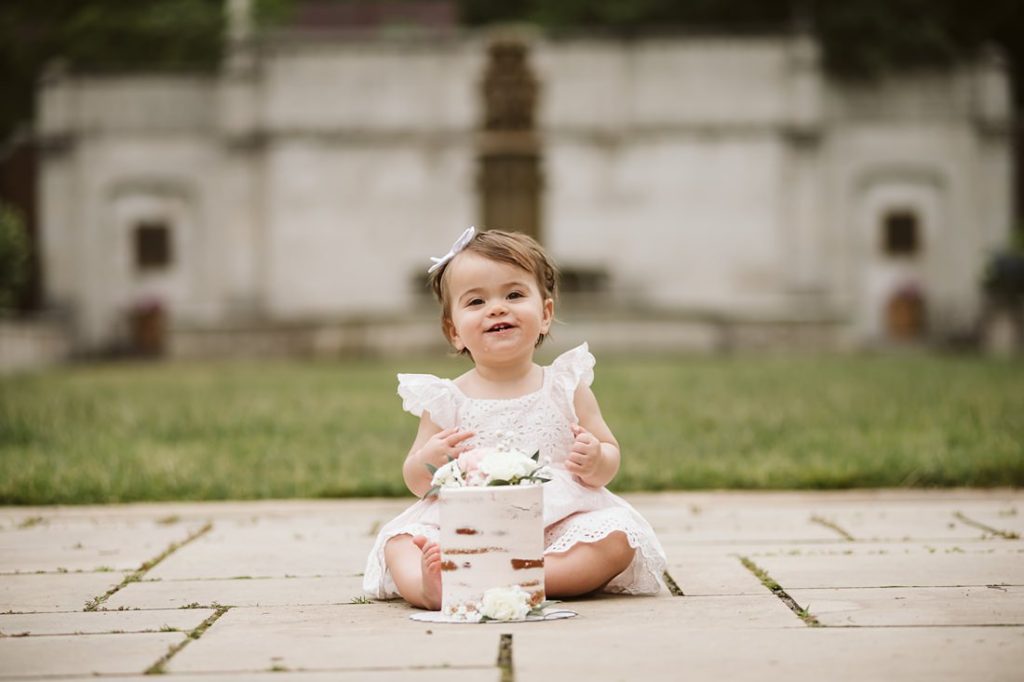 A portrait of a one year old girl with her smash cake near Pittsburgh. Portrait by Laura Mares Photography, Pittsburgh Family Photographer
