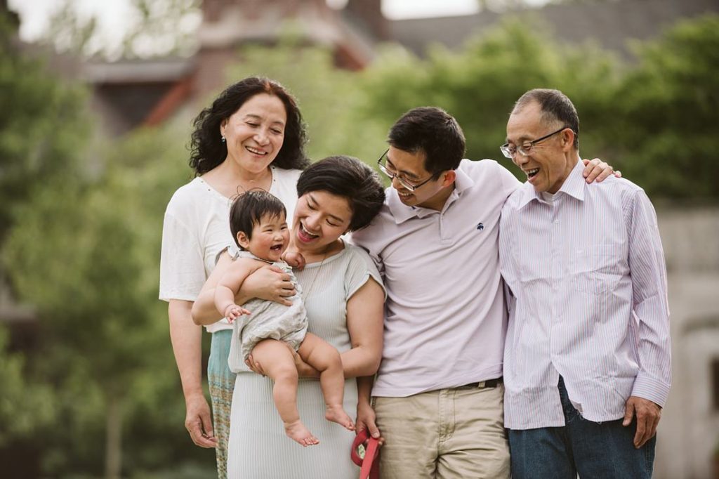 A portrait of a family laughing together in a park near Pittsburgh. Portrait by Laura Mares Photography, Pittsburgh Family Photographer