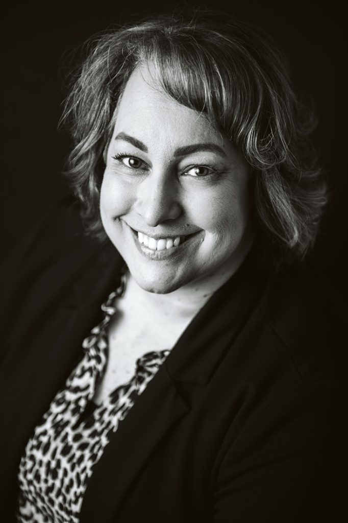 A black and white portrait of a women sitting in the studio, Pittsburgh. Portrait by Laura Mares Photography, Pittsburgh Portrait Photographer