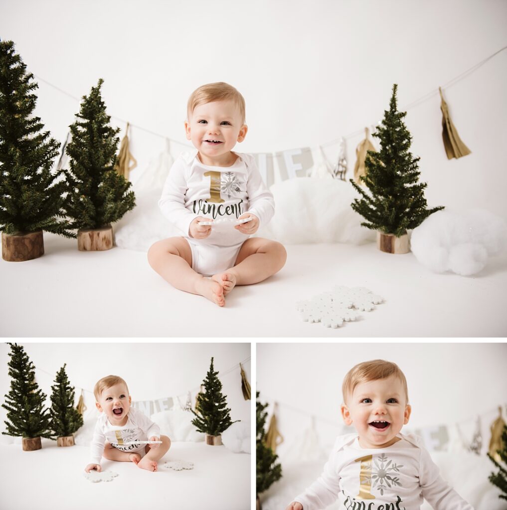 1st birthday boy sitting in front of a first birthday banner in studio. Photo by Laura Mares Photography, Pittsburgh Baby Photographer.