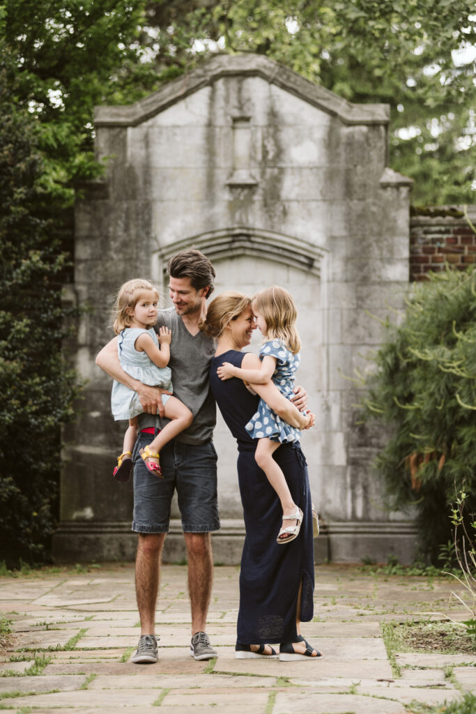 family of four standing together in mellon park