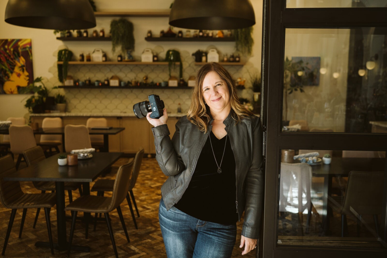 personal branding portrait of a photographer standing in a restaurant