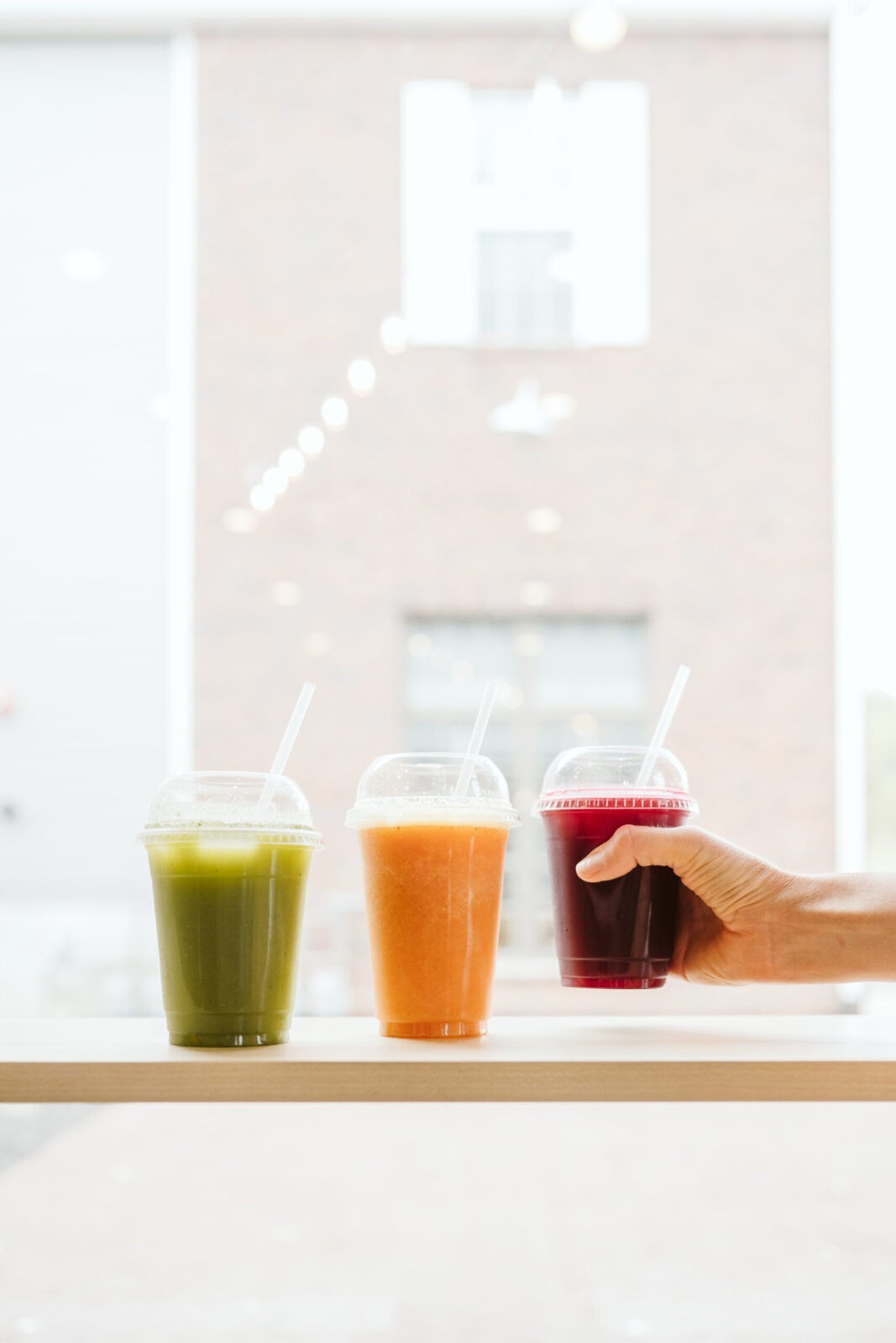 personal branding portrait of health coach reaching for juice