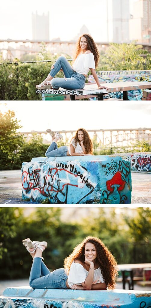 High school senior girl posing for senior photos in color park in downtown Pittsburgh at sunset