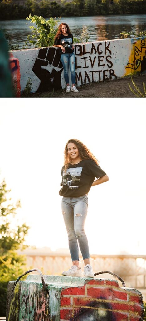 High school senior girl posing for senior photos in color park in downtown Pittsburgh during golden hour