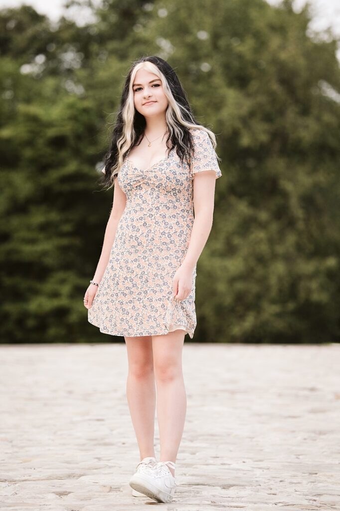 senior girl walking on a cobble stone driveway near Pittsburgh, PA during her senior picture session