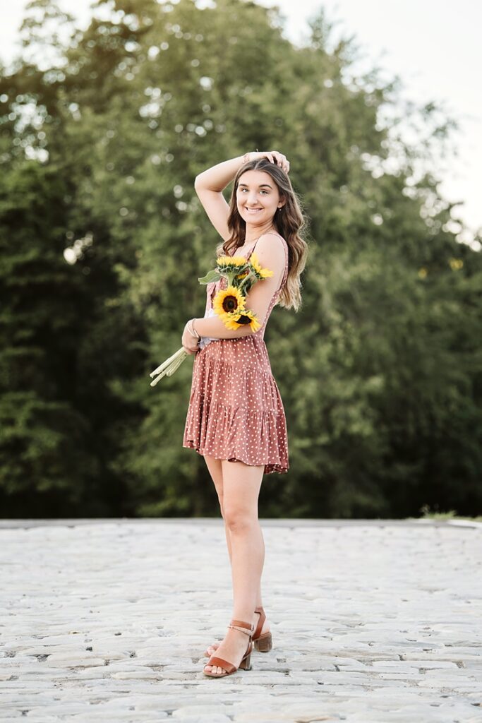 girl posing for senior pictures at Hartwood Acres