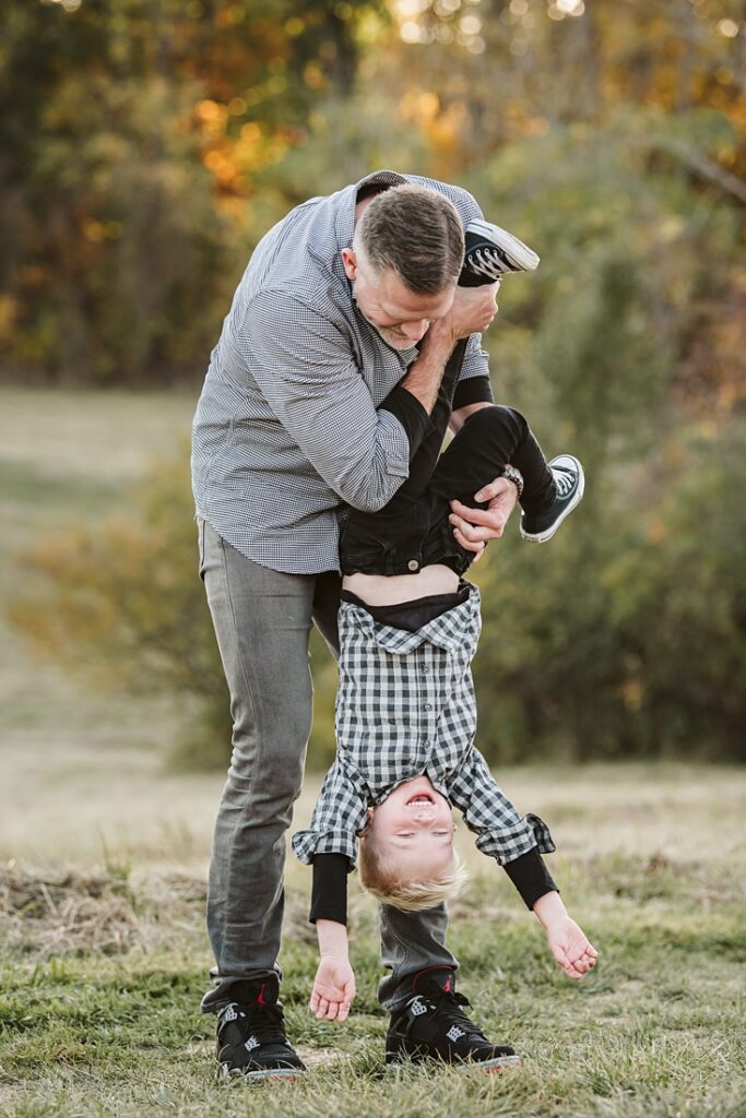 a father and son playing during a photo session