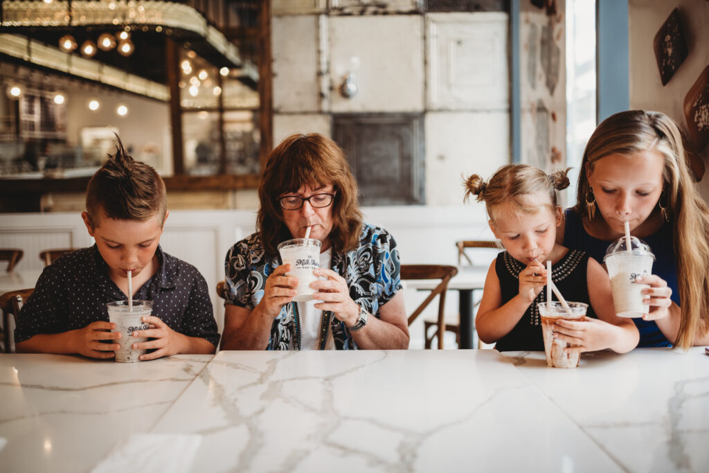 A grandma with her grandkids drinking milkshakes at Pittsburgh's Milkshake Factory