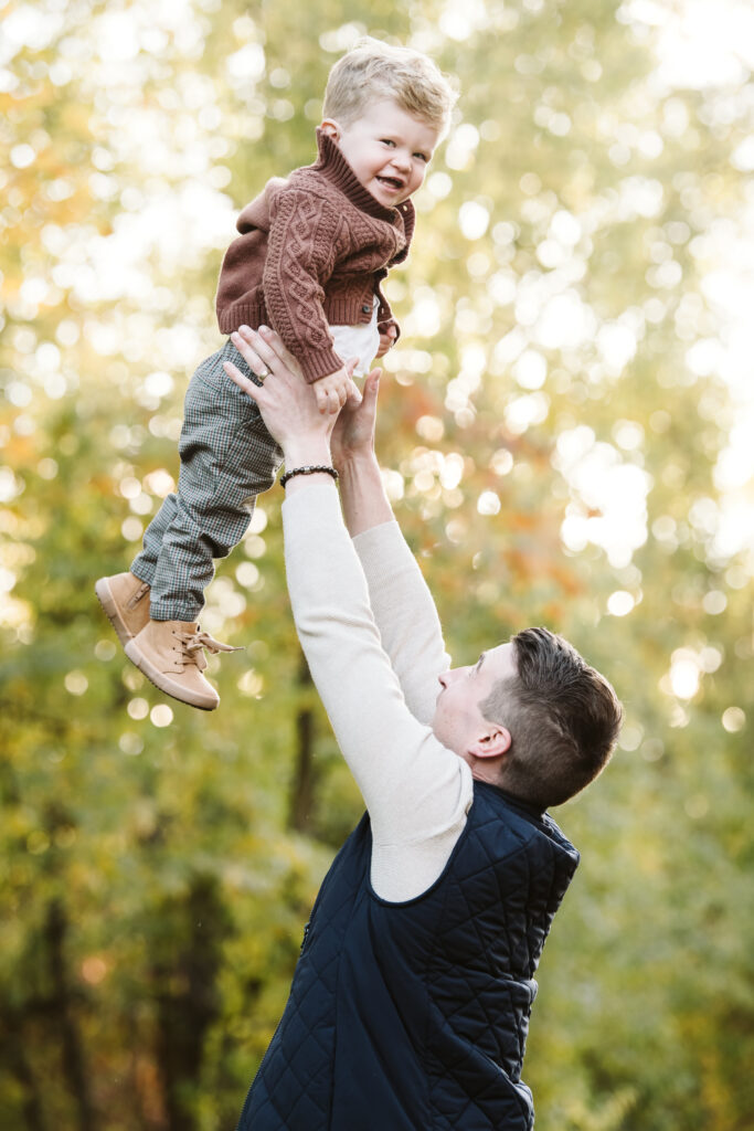 dad playing with child during family photo session