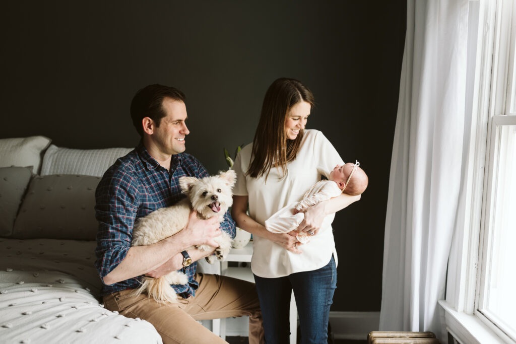 lifestyle newborn family picture with white dog with beautiful natural light