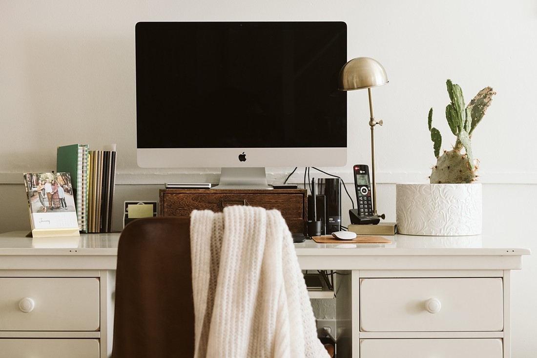 photo of a white desk, iMac, and cactus