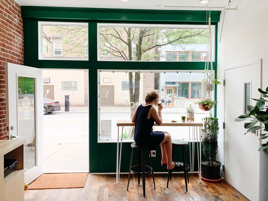 senior girl sipping matcha tea in Lawrenceville's Mosaic Leaf cafe