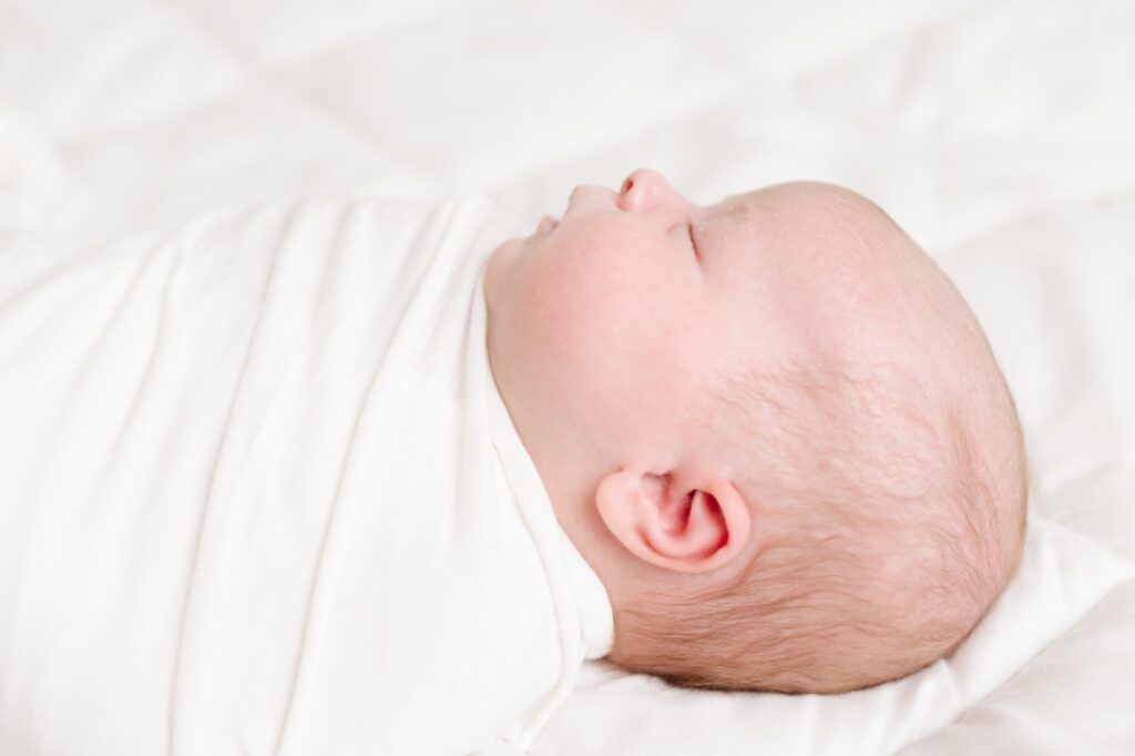 simple white studio newborn profile portrait