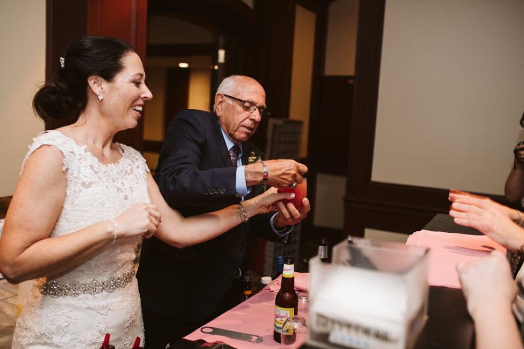The bride and her dad serving drinks at the wedding reception