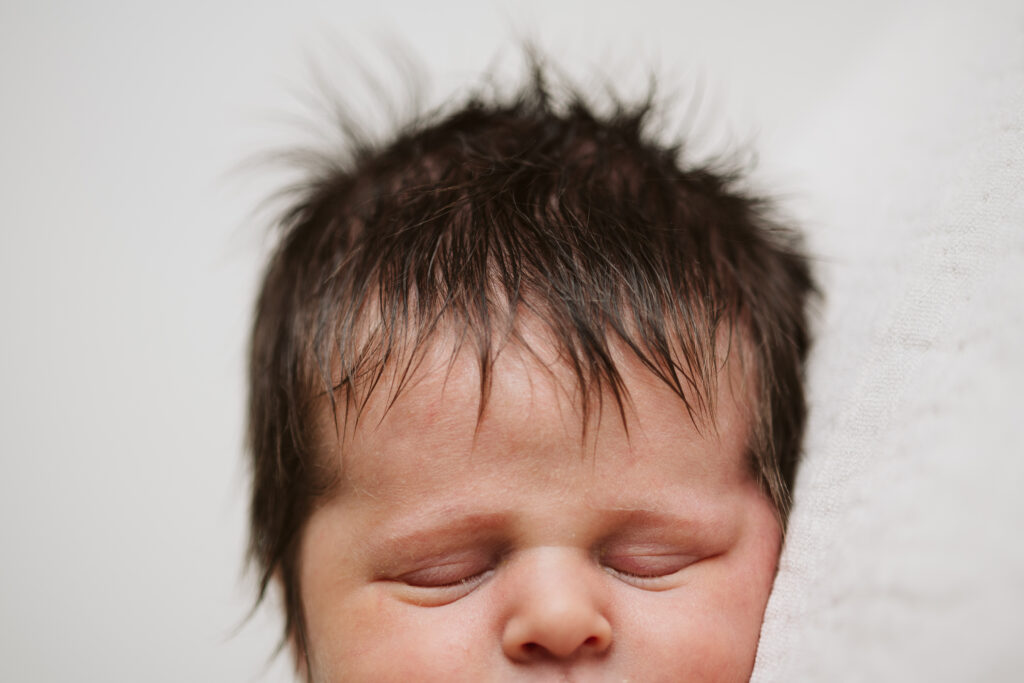 close up portrait of baby's hair, eyes and nose