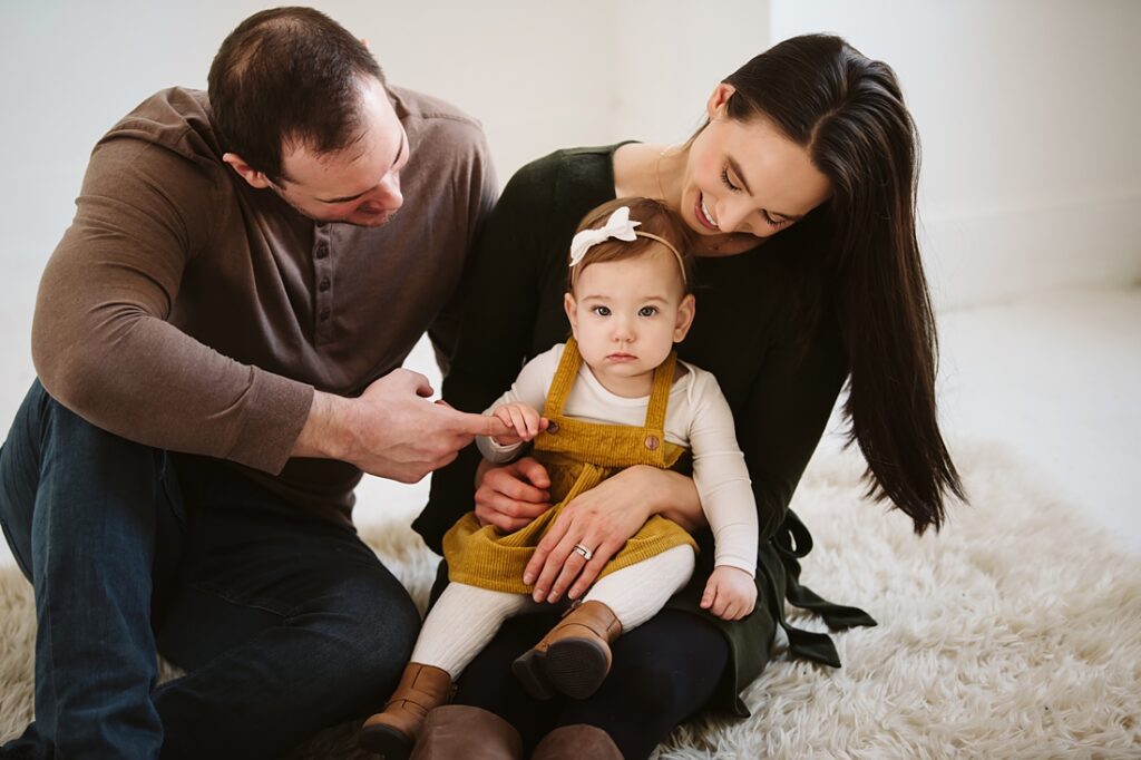 first birthday portrait of baby girl with parents