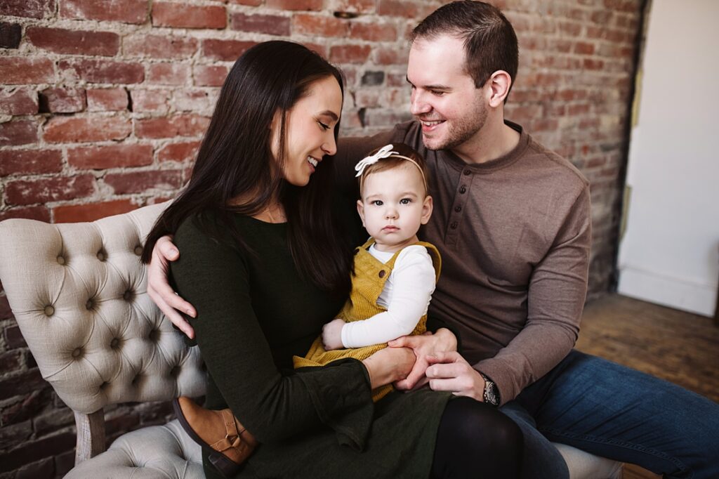 first birthday portrait of baby girl with parents