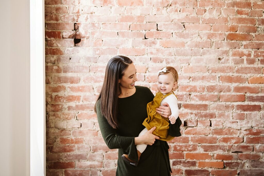 mom holding baby girl in a Pittsburgh photo studio