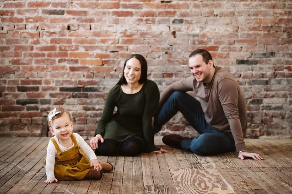 first birthday portrait of baby girl with parents