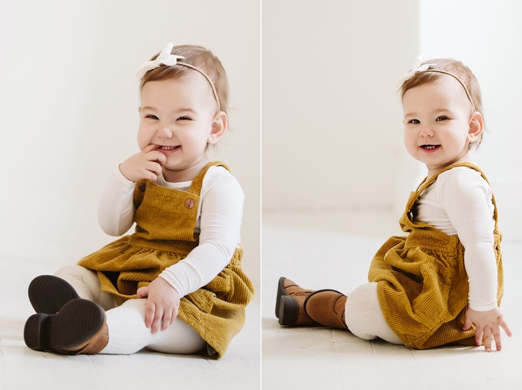 first birthday portrait of baby girl wearing a mustard jumper
